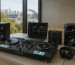 Full DJ gear setup in Australia with controller, mixer, headphones, speakers, and DJ software in a modern indoor environment.